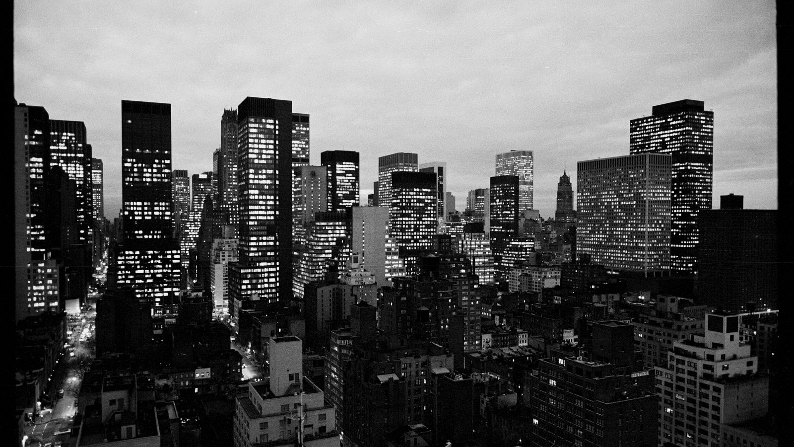 The Manhattan skyline in the evening with building lights coming on